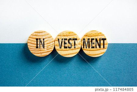 Investment symbol. Concept word Investment on beautiful wooden circles. Beautiful blue white background. Business investment concept. Copy space. 117484805