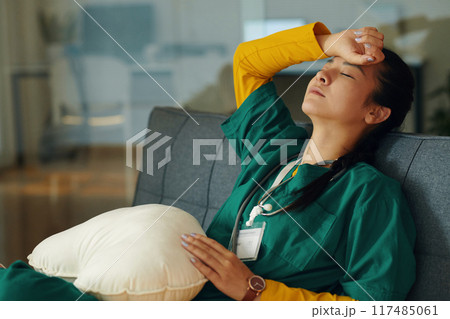 Tired Nurse Resting on Break in a Hospital Room Tired Nurse Resting on Break in a Hospital Room 117485061
