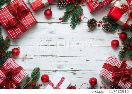 Christmas gift box. Christmas presents in red boxes at white wooden table. Flat lay with copy space. 117485919