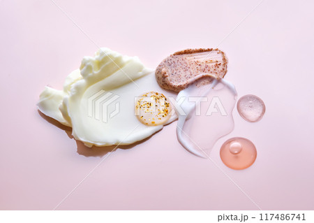 Different cosmetic textures on a delicate peach background. Different cosmetic textures on a delicate peach background. 117486741