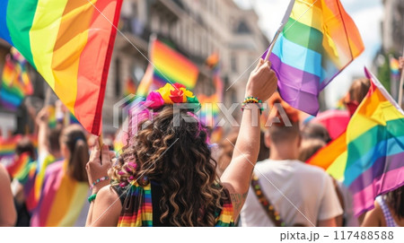 Crowd celebrating with rainbow flags at a public event 117488588