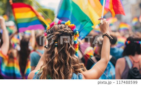 Crowd celebrating with rainbow flags at a public event 117488599