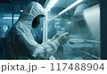 In a sterile laboratory setting, a dedicated scientist is performing experiments 117488904