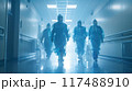 Healthcare Workers in PPE Suits Walking through Hospital Hallway 117488910