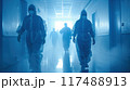 Healthcare workers in protective gear walk through hospital corridor  117488913