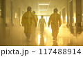 Healthcare professionals in protective suits navigating a sterile corridor  117488914