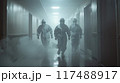 Medical team wearing protective gear rushing urgently through hospital corridor  117488917