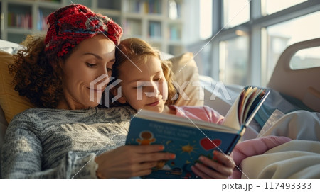 Volunteer reading a book to a child in a hospital 117493333