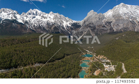 Aerial view of Jade Dragon Snow Mountain (or MtYulong) seen from blue moon valley scenic area in Yulong Naxi Autonomous County, Lijiang, in Yunnan province, China. 117493592