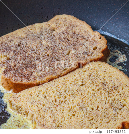 Cooking french toast in a pan on butter 117493851