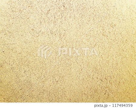 明るく白茶けた砂色の土壁のなかに藁の風合いが残る表面の横長の背景画像 明るく白茶けた砂色の土壁のなかに藁の風合いが残る表面の横長の背景画像 117494359