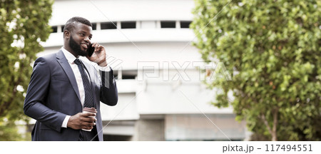 Always In Touch. African American Businessman Talking On Mobile Phone During Coffee Break In City. Free space 117494551