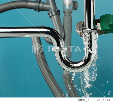 Heavy Duty Wrench fix Water leak under sink. Drain sink leak water from many pipe hose plumbing in bathroom and repair by wrench tools as water splash drop. Blue background isolated Heavy Duty Wrench fix Water leak under sink. Drain sink leak water from many pipe hose plumbing in bathroom and repair by wrench tools as water splash drop. Blue background isolated 117495834