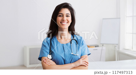 Happy Intern With Crossed Arms Looking At Camera During Conference In Meeting Room Happy Intern With Crossed Arms Looking At Camera During Conference In Meeting Room 117497313