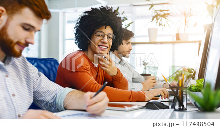 Work at IT company, friendly black guy smiling at camera at coworking space, panorama Work at IT company, friendly black guy smiling at camera at coworking space, panorama 117498504