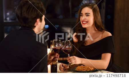 Sweet couple having romantic dinner in restaurant. Happy lovers celebrating anniversary together concept Sweet couple having romantic dinner in restaurant. Happy lovers celebrating anniversary together concept 117498718