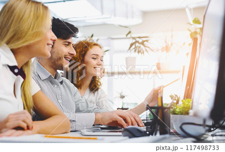 Young creative team discussing new marketing strategy, sitting together in office, empty space Young creative team discussing new marketing strategy, sitting together in office, empty space 117498733