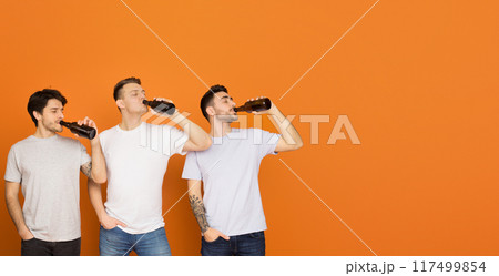 Three european men enjoy drinking soda together, signifying friendship and casual leisure times, copy space 117499854