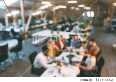 Corporate employees working at coworking place, discussing project at workplace, blurred photo Corporate employees working at coworking place, discussing project at workplace, blurred photo 117500098