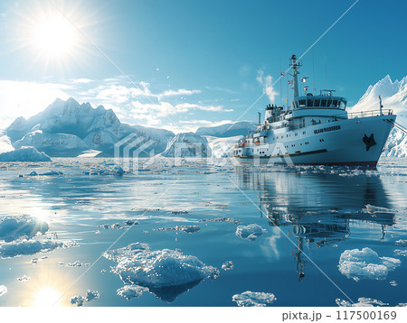 A research vessel navigates through the icy waters of the Arctic Ocean, surrounded by towering icebergs and brilliant sunlight. 117500169