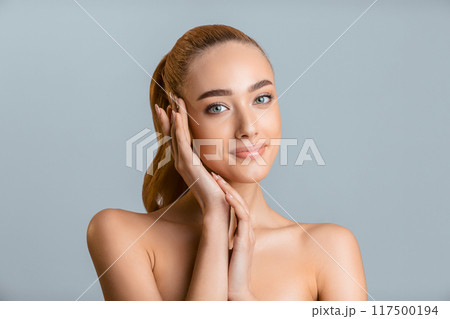 Skin care concept. Beautiful woman touching face with perfect fresh skin, grey background 117500194