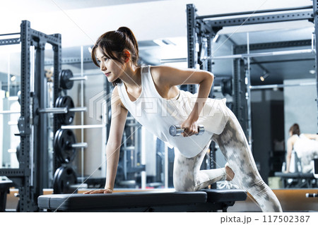 スポーツジムでトレーニングする若い女性 117502387