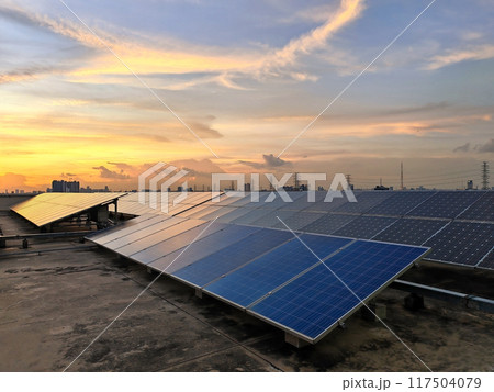 Solar panels install on roof of office building against sunset sky at dusk 117504079