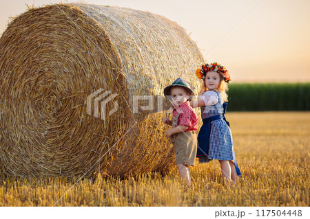 Child in wheat field with German bread Child in wheat field with German bread 117504448