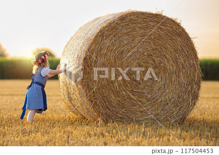 Child in wheat field with German bread Child in wheat field with German bread 117504453