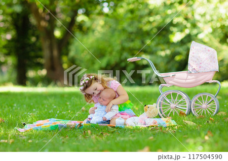 Little girl playing with baby brother 117504590