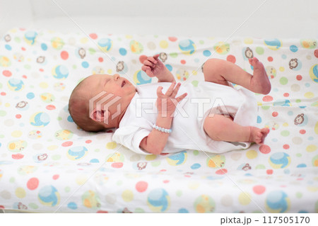 Newborn baby boy in hospital cot Newborn baby boy in hospital cot 117505170