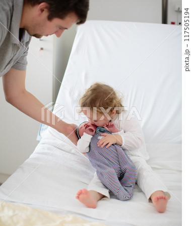 Siblings meet newborn baby in hospital Siblings meet newborn baby in hospital 117505194