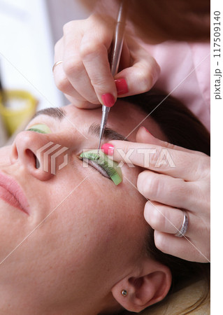 Coloring, curling, lamination, eyelash lift. Eyelash care procedures. Lamination of eyelashes. Eyelash extension for girl in beauty salon. Concept of beauty. Coloring, curling, lamination, eyelash lift. Eyelash care procedures. Lamination of eyelashes. Eyelash extension for girl in beauty salon. Concept of beauty. 117509140
