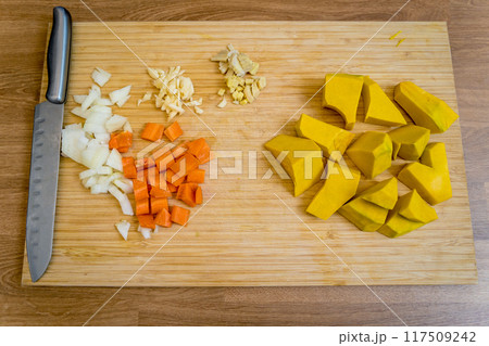Cutting board with ingredients for preparing pumpkin porridge with tofu and vegetables 117509242