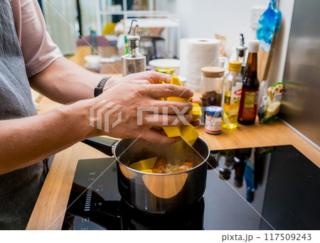 Chef at the kitchen preparing pumpkin porridge with tofu and vegetables Chef at the kitchen preparing pumpkin porridge with tofu and vegetables 117509243