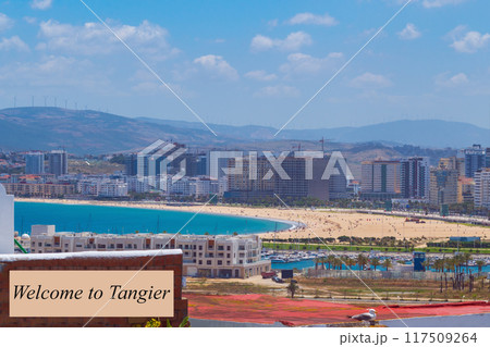 Advertising panoramic view of the beach with the ocean from a height with the inscription Welcome to Tangier, to advertise tourist holidays in the resorts of the city, Morocco, Africa Advertising panoramic view of the beach with the ocean from a height with the inscription Welcome to Tangier, to advertise tourist holidays in the resorts of the city, Morocco, Africa 117509264