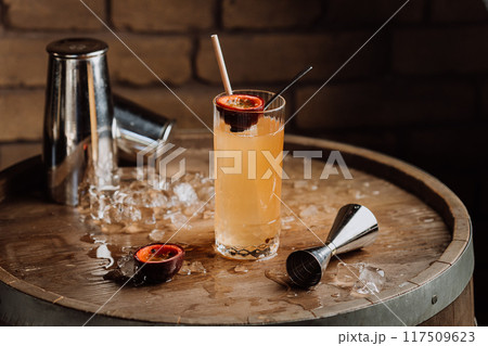 Refreshing passion fruit cocktail in highball glass, for summer vibes and tropical-themed events 117509623