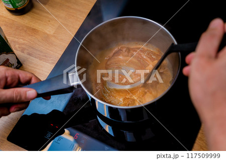 Chef at the kitchen preparing massaman curry with sweet potato and many spices Chef at the kitchen preparing massaman curry with sweet potato and many spices 117509999