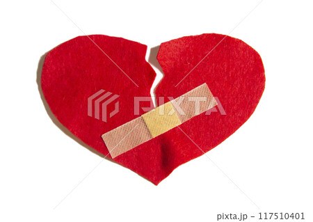 Broken heart and glued together with a band-aid. A heart from felt. A concept about broken love. Heart with plaster isolated on white background Broken heart and glued together with a band-aid. A heart from felt. A concept about broken love. Heart with plaster isolated on white background 117510401
