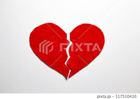 Broken red heart made of felt. Broken love concept.  A broken heart isolated on a white background. A  pain in my heart 117510410