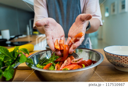 Chef at the kitchen preparing spicy glass noodle salad 117510987