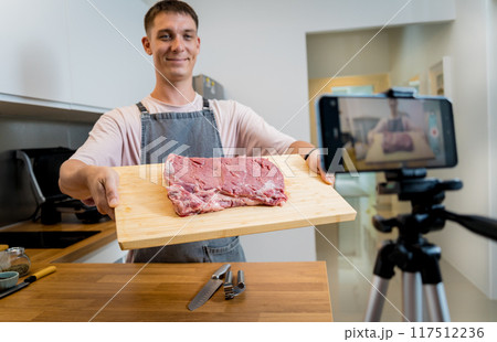 The chef is broadcasting live from workshop how to prepare a beef steaks on the electric grill The chef is broadcasting live from workshop how to prepare a beef steaks on the electric grill 117512236