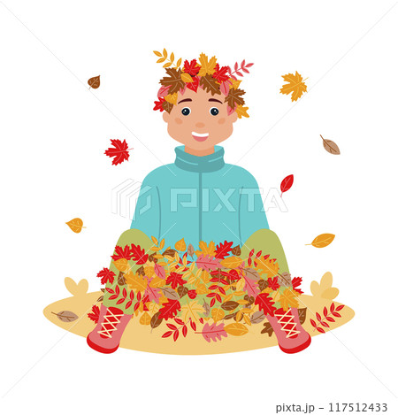 A happy boy wearing a wreath of leaves on his head is sitting in a pile with colorful leaves. Leaf fall. The autumn season. Vector illustration in a flat style on a white background. 117512433