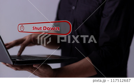 Young man hand touching laptop Shut Down button press power OFF Young man hand touching laptop Shut Down button press power OFF 117512687