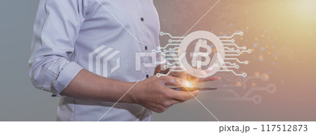 Young man hand uses smartphone and bitcoin 117512873