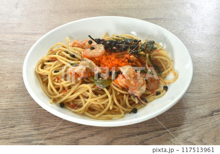 spicy stir fried spaghetti slice squid and shrimp with chili and basil leaf topping shrimp egg in sauce on plate  117513961