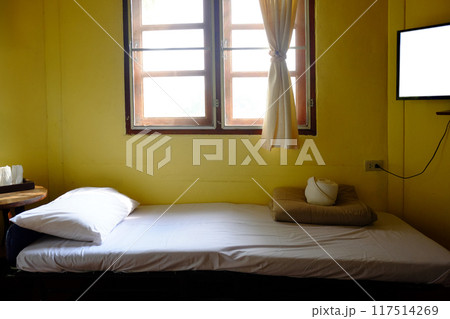 Vintage white bed in pastel yellow bedroom in homestay Vintage white bed in pastel yellow bedroom in homestay 117514269