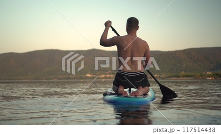 Experience Adventurous Paddleboarding at Sunset on the Serene Waters of Natures Beauty Experience Adventurous Paddleboarding at Sunset on the Serene Waters of Natures Beauty 117514438
