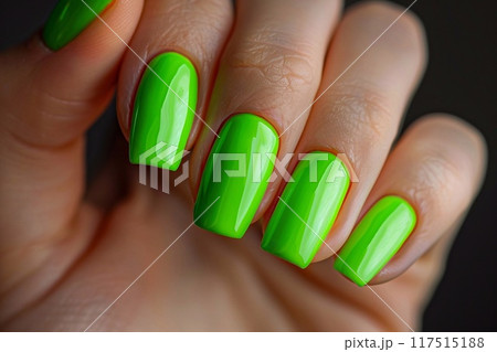 Female hand with green nail design. 117515188