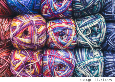 Colourful ball of yarn in storage. Warm wool yarn in vibrant colors. Knitting hobby. Row of vivid yarn. Handiwork store. Knit background. Handcraft concept. Knit pattern. 117515229